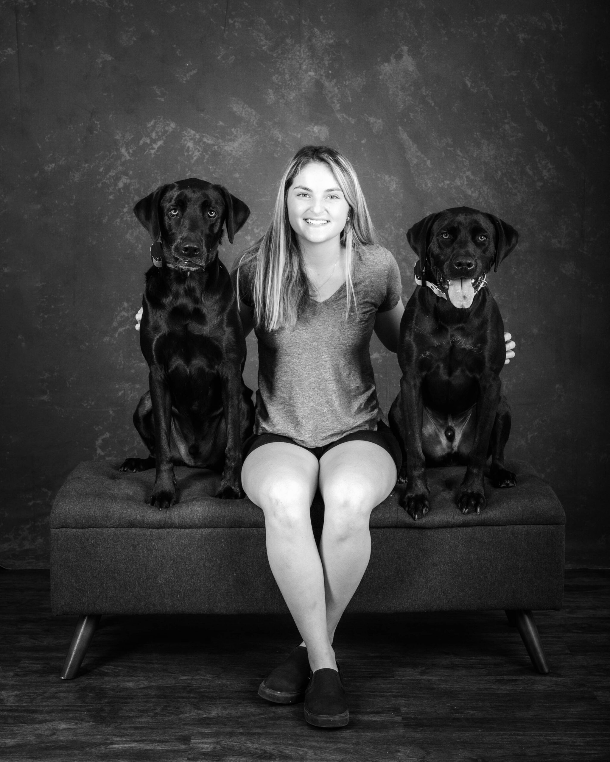 Sofia Gonzales smiling with dogs in studio